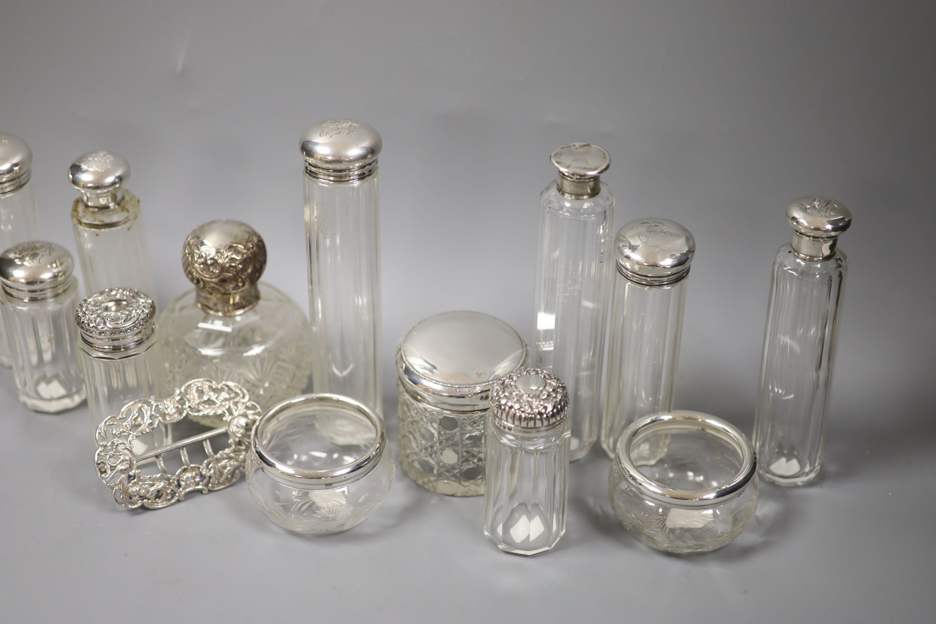 Assorted silver mounted toilet jars and a late Victorian silver belt buckle, London, 1897.